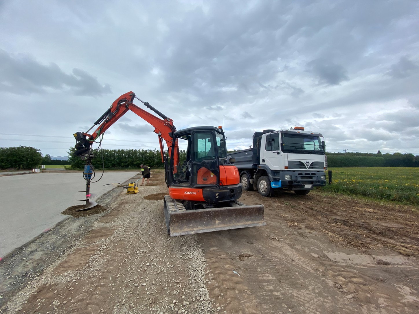 Excavator and truck preparing a rural pad
